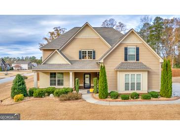 Charming two-story home boasts mature landscaping, inviting entrance, and a welcoming facade at 108 Donovan Ave, Locust Grove, GA 30248