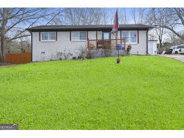 Charming one-story home featuring a brick facade, well-maintained lawn, and inviting front porch at 2827 Somerton Dr, Morrow, GA 30260
