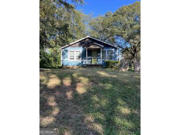 Charming single story house with blue siding and front porch with bright yellow door at 1150 Mayland Sw Cir, Atlanta, GA 30310