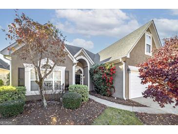 Charming single-Gathering home featuring a well-maintained lawn, an inviting front porch, and lush landscaping at 152 Wexford Ct, Stockbridge, GA 30281