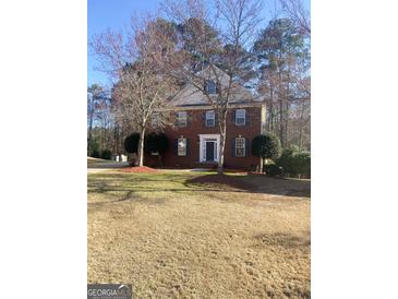 Charming two-story brick home with a well-maintained yard and mature trees in a quiet neighborhood at 460 Ridgewood Dr, Fayetteville, GA 30215