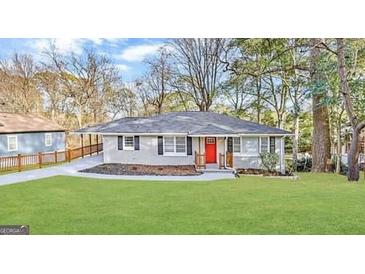 Charming single-story home boasts a well-manicured lawn and a vibrant red front door at 791 Gertrude Nw Pl, Atlanta, GA 30318