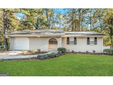 Charming brick home with a well-manicured lawn and beautiful landscaping at 2205 Chestnut Hill Cir, Decatur, GA 30032