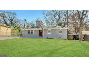 Charming single-story home with a well-manicured front lawn at 2690 Rollingwood Se Ln, Atlanta, GA 30316