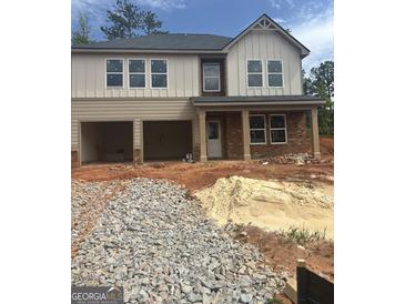 Two-story home with attached two-car garage and a charming brick-columned porch at 742 Great Oak Pl # 13, Villa Rica, GA 30180
