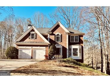 Charming two-story brick home with a well-manicured front yard and attached two-car garage, radiating curb appeal at 6302 Manassas Nw Pass, Acworth, GA 30101