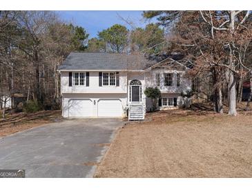 Charming two-story home featuring a two-car garage, black shutters, and a classic front door at 70 Willow Bend Nw Dr, Cartersville, GA 30121