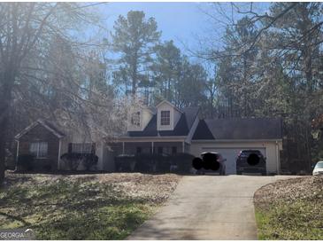 Charming two-story home with a well-manicured lawn and inviting front porch at 945 Bethany Rd, Covington, GA 30016