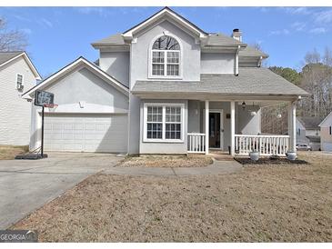 Charming two-story home with covered front porch and attached two-car garage at 747 S Fairfield Dr, Peachtree City, GA 30269