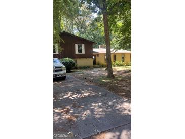 Charming home with a brick and siding exterior, set back from the street with mature trees at 4571 Scarborough Rd, South Fulton, GA 30349