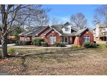 Charming red brick home featuring mature landscaping and classic architectural details at 3434 Estels Ln, Conyers, GA 30013