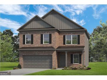 Charming two-story brick home with a two-car garage and classic architectural details at 10459 Trellis Lane (Lot 27), Hampton, GA 30228