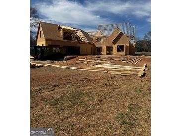 Exterior view of new construction with wood frame and gabled roof under a clear blue sky at 462 Snead Road # 2, Fayetteville, GA 30215