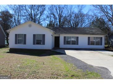 Charming single-story home with a well-maintained front yard and a driveway at 343 Kate Dr, Forest Park, GA 30297