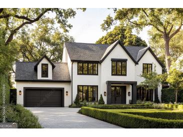 Elegant two-story home boasts a symmetrical facade, a well-manicured lawn, and a paved driveway at 554 Palm St, Holly Springs, GA 30115