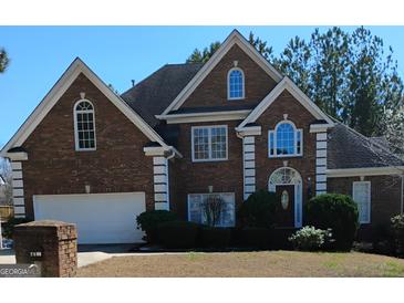 Charming two-story brick home featuring manicured landscaping and a classic architectural design at 2895 Battlecrest Dr, Decatur, GA 30034
