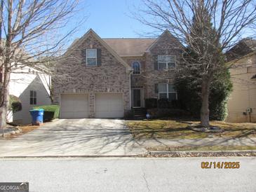 Charming brick home with a two-car garage and well-maintained lawn at 4286 Rosehall Ct, South Fulton, GA 30349