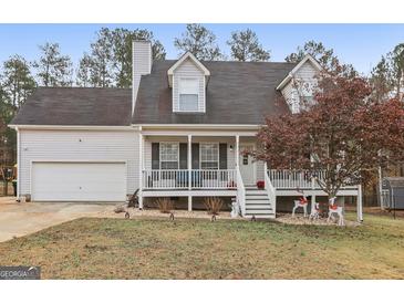 Charming home with a covered front porch, two-car garage, and appealing exterior at 1144 Pickets Ridge Dr, Locust Grove, GA 30248