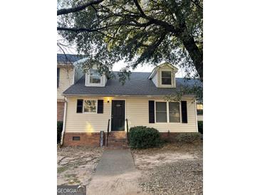Charming townhouse with a well-maintained front yard and dormer windows at 5509 Park Place South, Atlanta, GA 30349