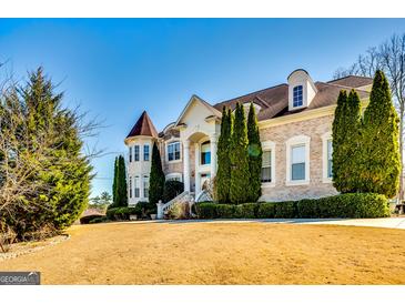 Elegant brick home boasts manicured lawn, lush landscaping, and stately architectural details at 1214 Greenridge Ln, Lithonia, GA 30058
