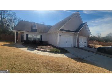 Charming single-Gathering home with two car garage, landscaped yard, and manicured lawn at 505 City Park Dr, Mcdonough, GA 30252