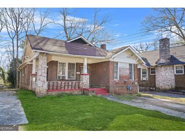 Charming brick home with a well-maintained lawn and traditional architectural details at 732 Cascade Sw Ave, Atlanta, GA 30310