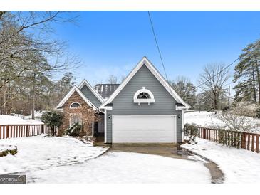 Charming home exterior featuring a two-car garage and a blend of siding and stone accents at 1116 5Th Nw St, Atlanta, GA 30318