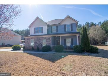 Charming two-story home featuring a stone facade and well-manicured landscaping at 4205 Lindsey Way, Conyers, GA 30013