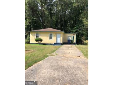 Charming single-story home with a well-maintained lawn and a private driveway at 3720 Asbury Sw Ln, Atlanta, GA 30331