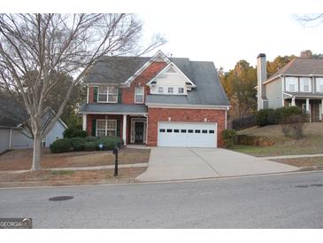 Charming two-story brick home with attached garage and well-manicured landscaping at 113 Lantana Dr, Locust Grove, GA 30248