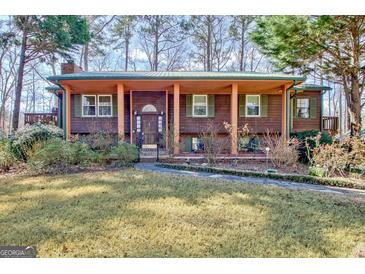 Charming single-Gathering home featuring a cozy front porch and well-maintained landscaping at 562 Adams Rd, Fayetteville, GA 30214