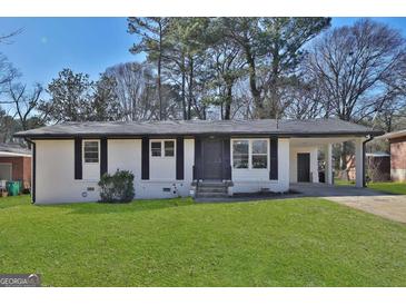 Charming single-story home with fresh, white paint, black trim, and a well-manicured front lawn at 3047 Horse Shoe Se Dr, Atlanta, GA 30316