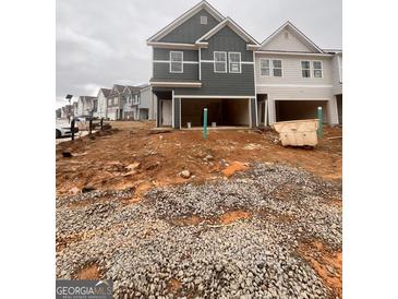 New construction townhomes feature an attached garage and modern architectural design at 44 Leggit Dr # 179, Villa Rica, GA 30180