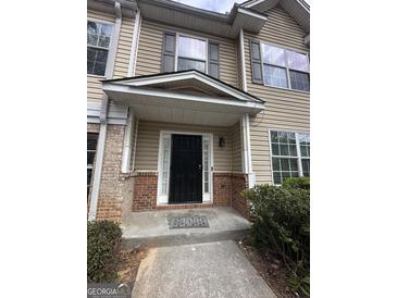 Inviting front porch with brick accents and a secure black metal entry door at 2747 Vining Ridge Ter, Decatur, GA 30034