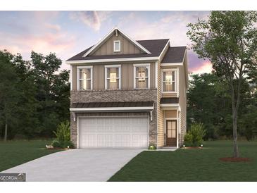Charming two-story home featuring a brick-and-siding facade, attached garage, and a well-manicured front lawn at 988 Sutherland Lane # 33, Lawrenceville, GA 30043