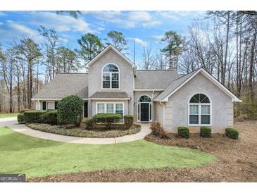 Charming two-story home with inviting front yard landscaping and a classic architectural style at 238 Harvest Trce, Sharpsburg, GA 30277