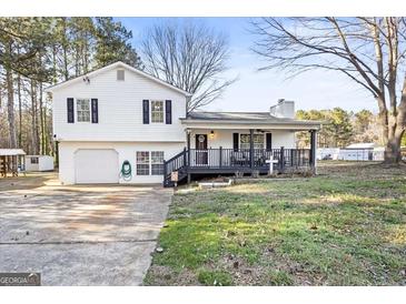 Charming two-story home with a welcoming front porch and attached garage at 916 Marshall Fuller Rd, Dallas, GA 30157