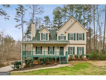Charming two-story home featuring a welcoming front porch and traditional architectural details at 12 Paces Lakes Overlook, Dallas, GA 30157