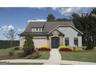 Charming exterior of a single-Gathering home with manicured lawn, stone accents, and welcoming front entrance at 2446 Naples St, Hoschton, GA 30548
