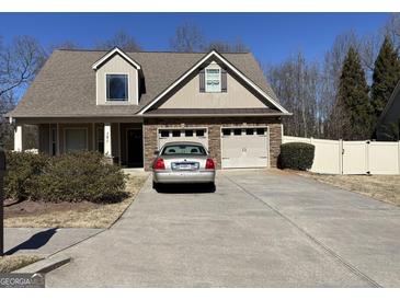 Charming two-story home with a two-car garage, manicured lawn, and lovely curb appeal on a sunny day at 101 Deer Park Dr, Carrollton, GA 30116