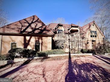 View of an elegant home with a unique brick driveway and manicured landscaping at 275 Old Mill Ct, Fayetteville, GA 30214