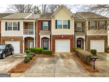 Charming townhomes with brick and siding exteriors, well-manicured lawns, and private driveways at 2786 Snapfinger Mnr, Decatur, GA 30035