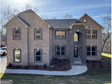 This is a charming two-story brick home with a well-manicured lawn and elegant architectural detailing at 5915 Langdale Chase # 16, Douglasville, GA 30135