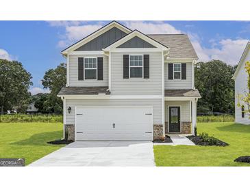 Charming two-story home featuring a modern design, well-manicured lawn, and a two-car garage at 287 Limestone Circle, Conyers, GA 30013
