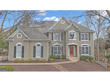 Charming two-story home featuring stucco and a symmetrical facade with a bright red front door at 804 Carnellian Ln, Peachtree City, GA 30269