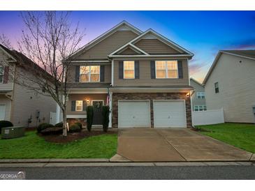 Charming two-story home featuring a two-car garage, stone accents, and well-manicured lawn at 70 High Point Way, Hiram, GA 30141