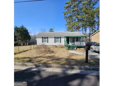Charming single-story home featuring a cozy front porch and a well-maintained yard at 4748 Ash St, Doraville, GA 30340