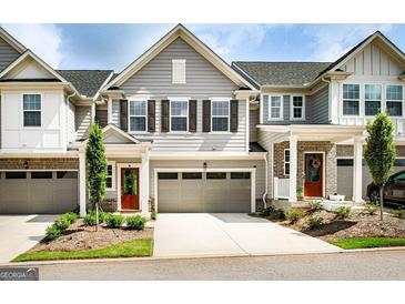 Charming townhome with gray siding, a two-car garage, and a neatly landscaped front yard at 14 Singleton Way, Peachtree City, GA 30269