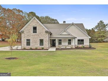 Charming two-story home with mixed siding, brick accents and a well manicured lawn at 110 Warren Way, Fayetteville, GA 30215