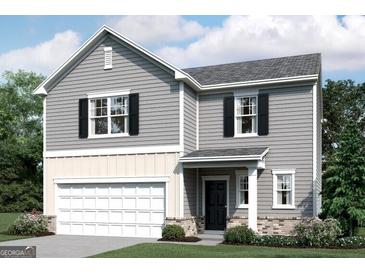 Charming two-story home with gray siding, black shutters, and a two-car garage at 7728 Sudbury Cir, Covington, GA 30014